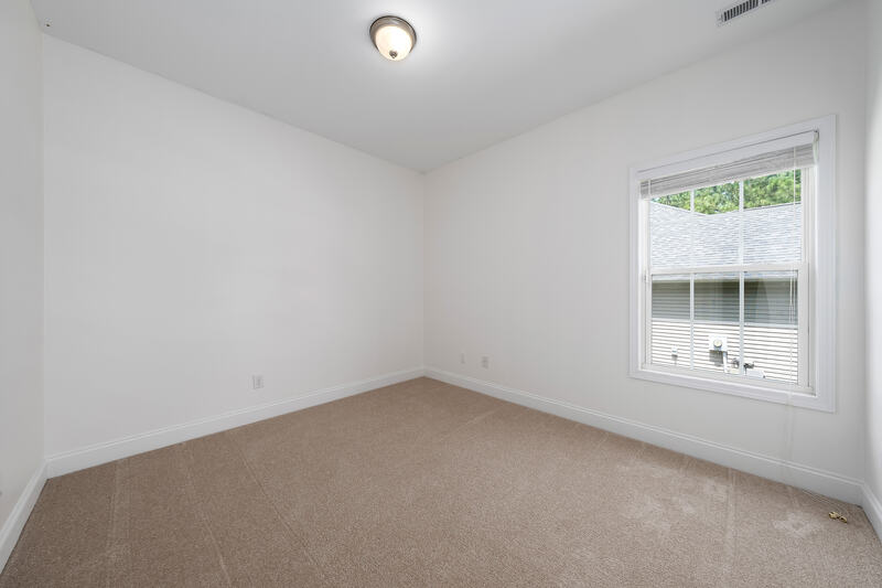 Third bedroom with carpet and a window