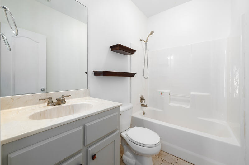 Hall bath with a tub and shower