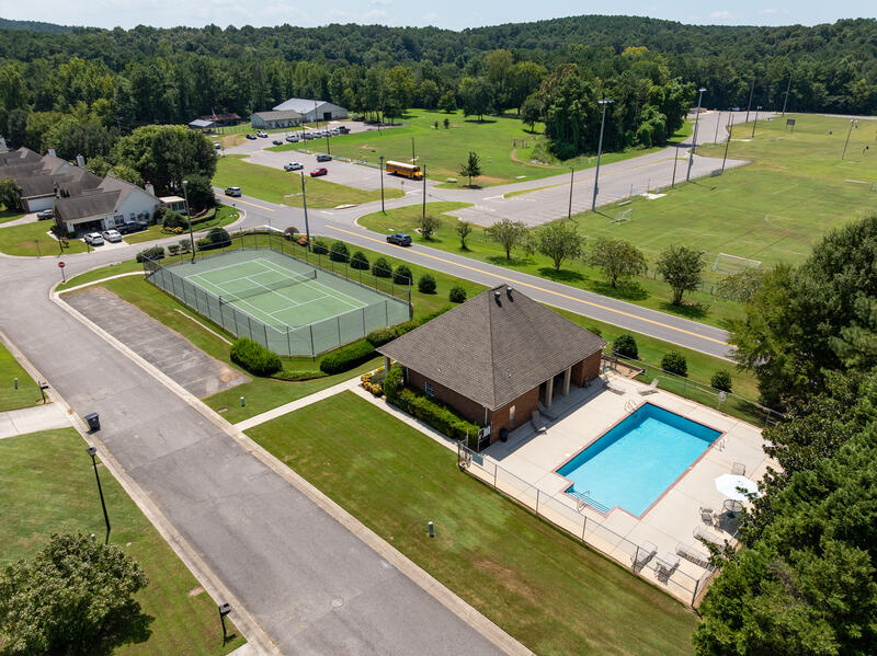 Aerial view of the community pool, clubhouse and tennis courts
